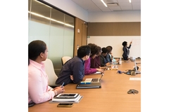 Image Women gathered in a boardroom.